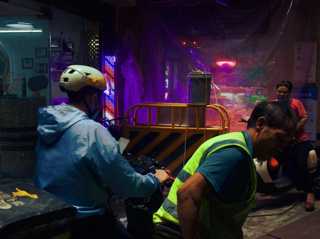 Floor manager directing crew on a television studio set
